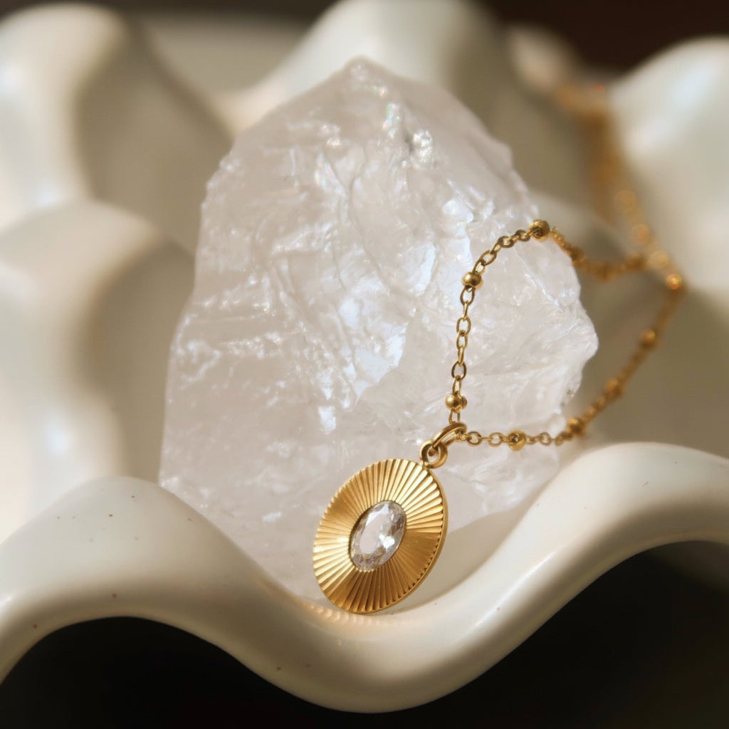Dainty diamond-like oval cut zircon stone detail in gold setting