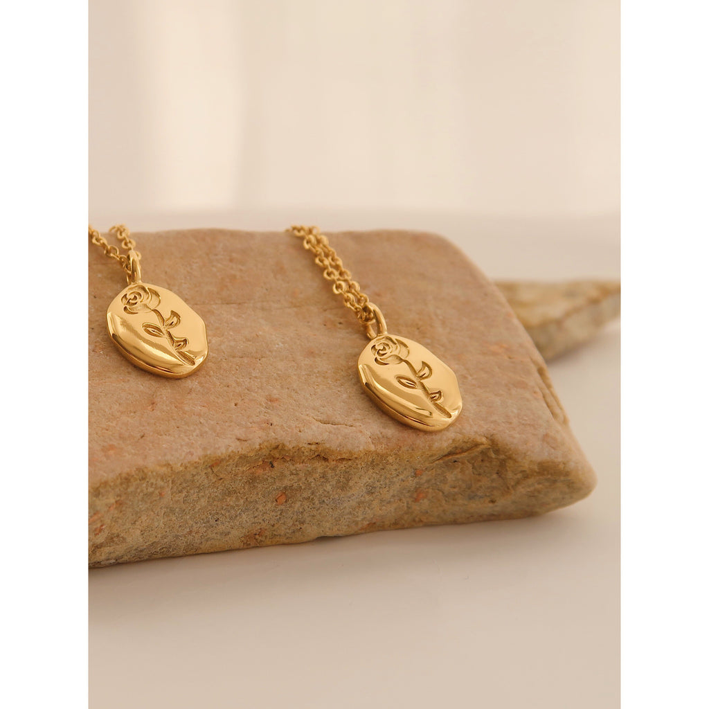 Gold rose flower pendant necklace on model - CC Jewelry