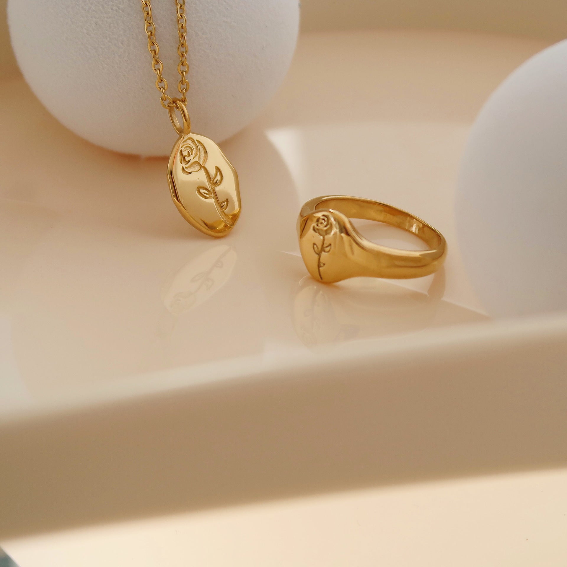 Gold rose flower pendant necklace on model - CC Jewelry