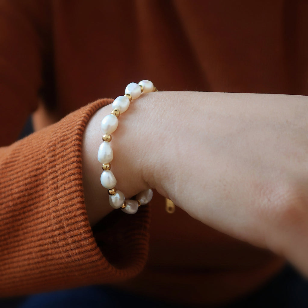 Unique organic shape and high luster of genuine baroque pearls on gold bracelet
