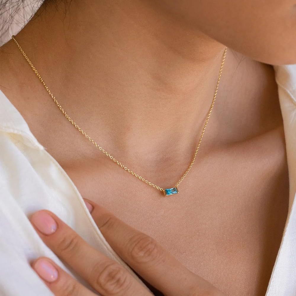 Close-up of minimalist silver clavicle chain with a sparkling square lucky stone