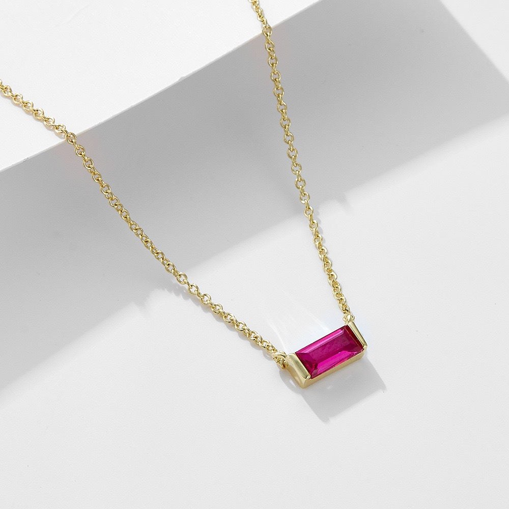 Close-up of minimalist silver clavicle chain with a sparkling square lucky stone