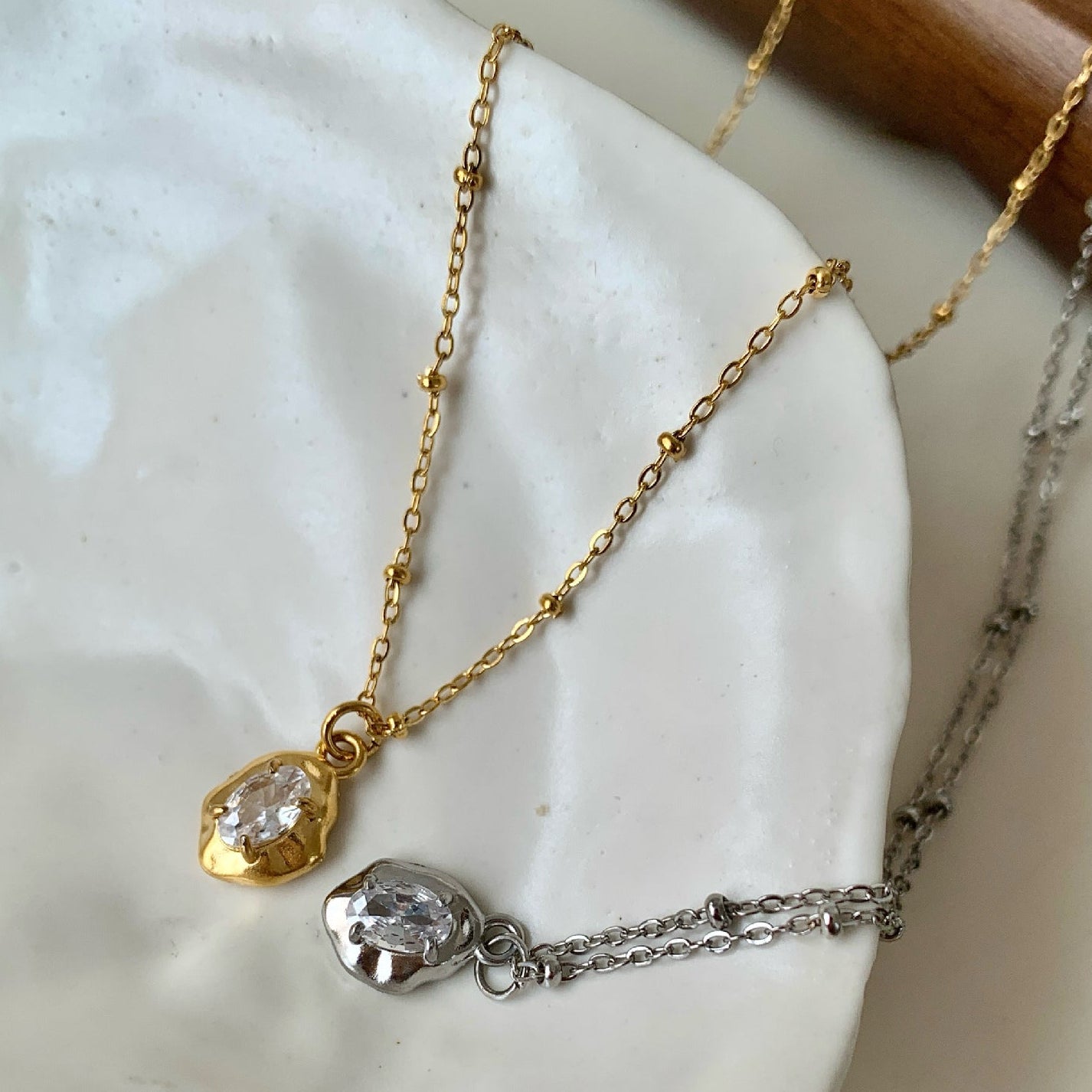 Organically shaped irregular zircon pendant necklace with gold titanium steel chain